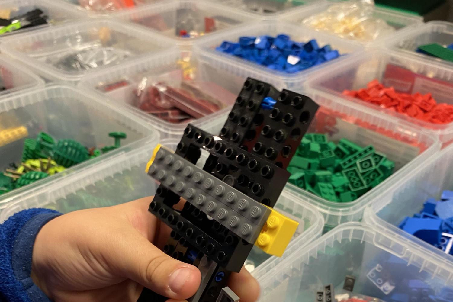 Händer som bygger med lego.